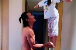 张晋双手托举女儿站立 小女儿笑容满面不害怕 