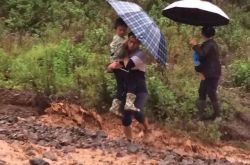 云南昆明现最帅小学老师 抱60多个孩子趟急流过河